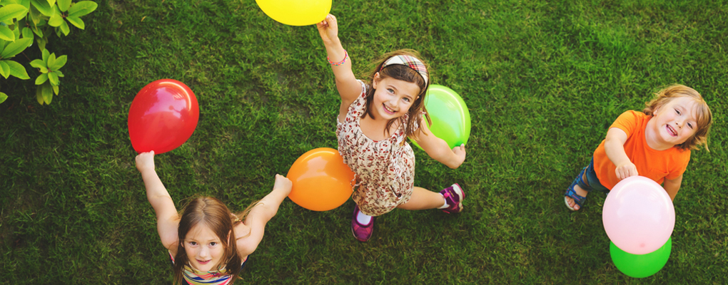 Kinder spielen mit Luftballons